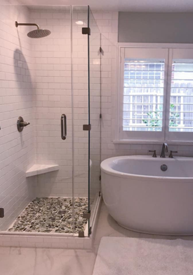 walk in shower with soaker tub, stone tile floor, subway tile shower surround