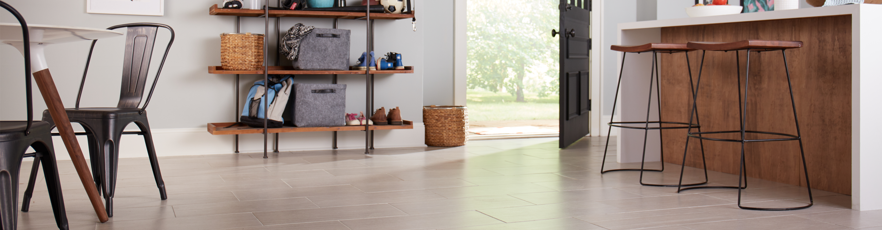Subway style tile floor in kitchen with barstools and counter 